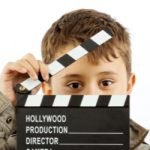 Promotional Video Production For Business showing a kid using a video clacker
